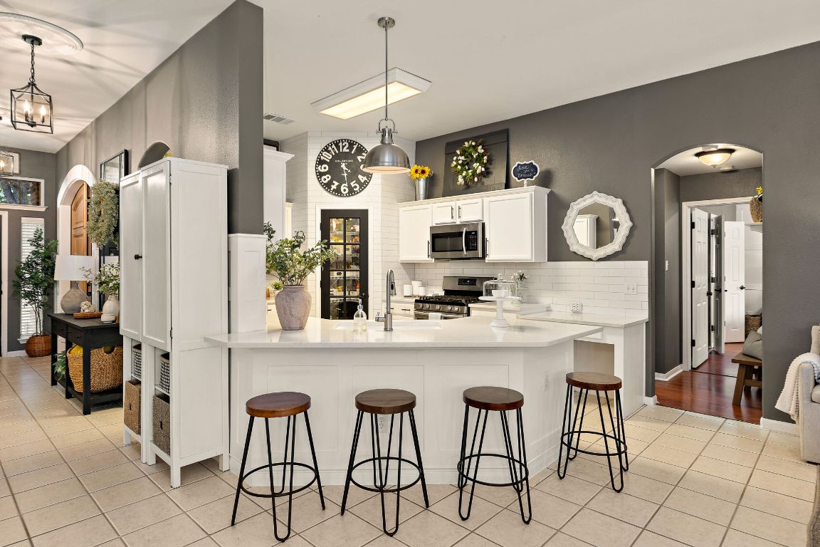 131 Chandler Pointe Loop Round Rock, TX 78665 - Photo 12 of 31 a kitchen with stainless steel appliances granite countertop a refrigerator and microwave