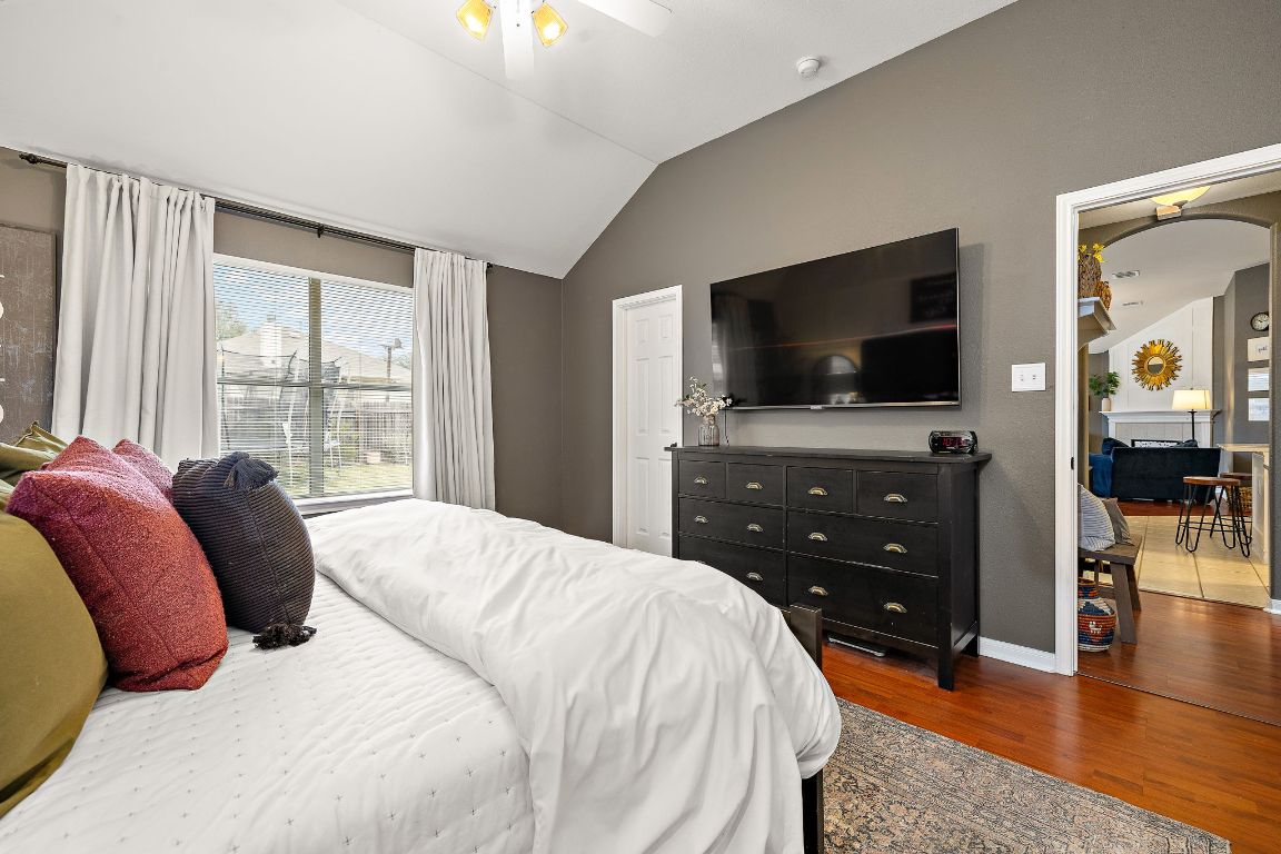 131 Chandler Pointe Loop Round Rock, TX 78665 - Photo 19 of 31 a bedroom with a bed and a flat screen tv