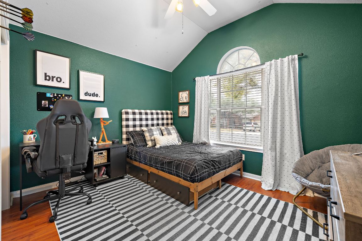 131 Chandler Pointe Loop Round Rock, TX 78665 - Photo 22 of 31 a bedroom with a bed and wooden floor