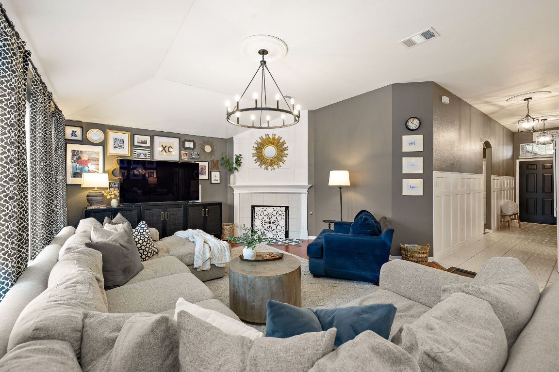 131 Chandler Pointe Loop Round Rock, TX 78665 - Photo 8 of 31 a living room with furniture a fireplace and a flat screen tv