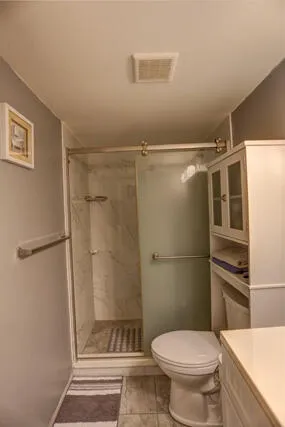a bathroom with a toilet and a shower