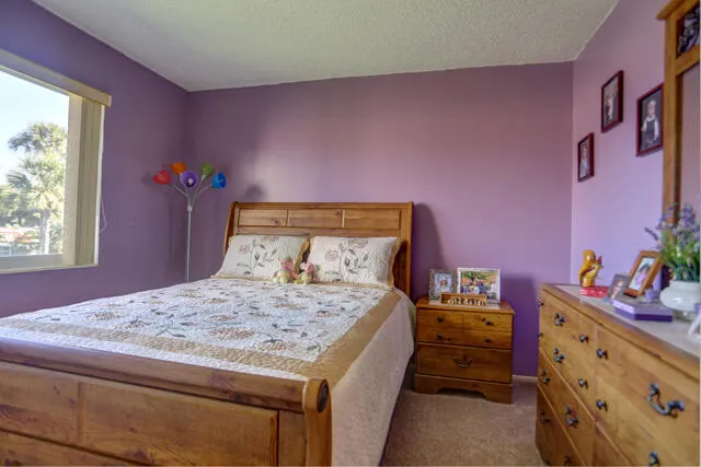 a bedroom with a bed and a dresser in it