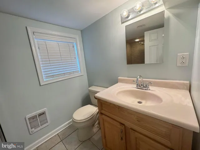 a bathroom with a sink a toilet and mirror