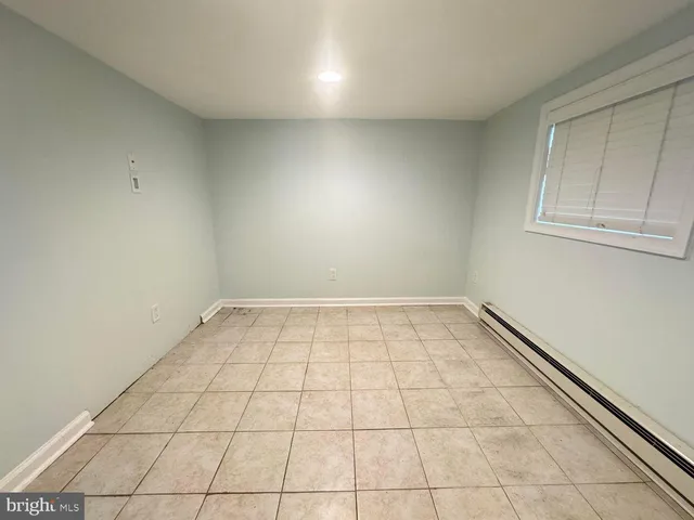 a view of a room with wooden floor and cabinets