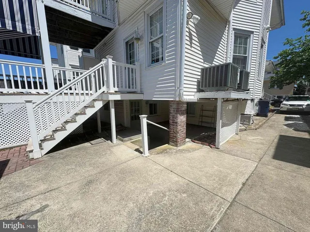 a view of a house with wooden floor and a small yard