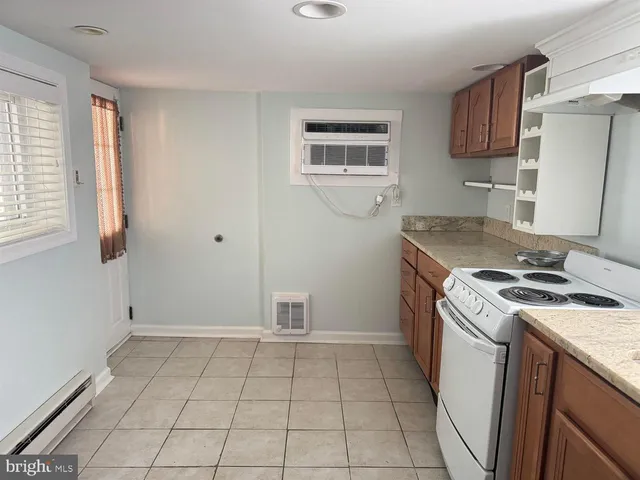 a kitchen with a stove top oven sink and cabinets
