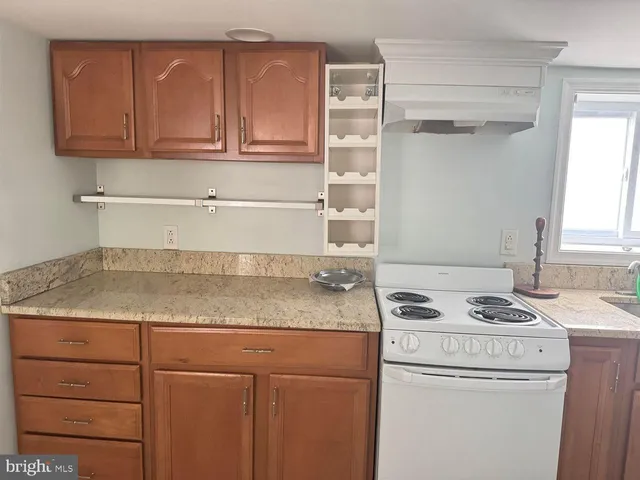 a utility room with granite countertop cabinets washer and dryer