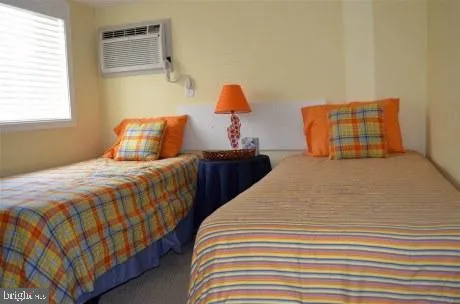 a bedroom with two beds and painting on the wall