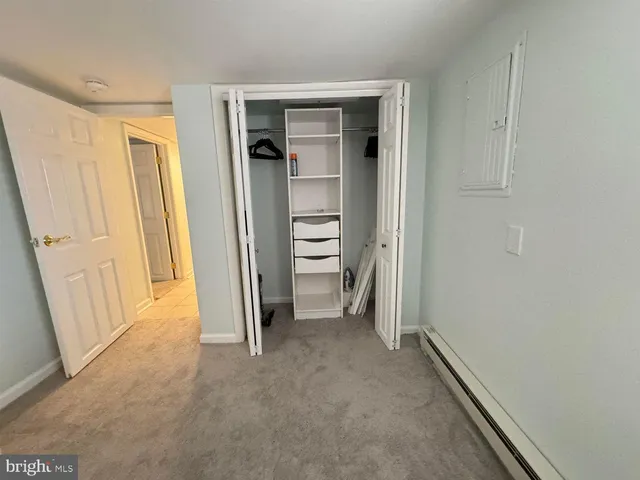 an empty room with a door and a hallway