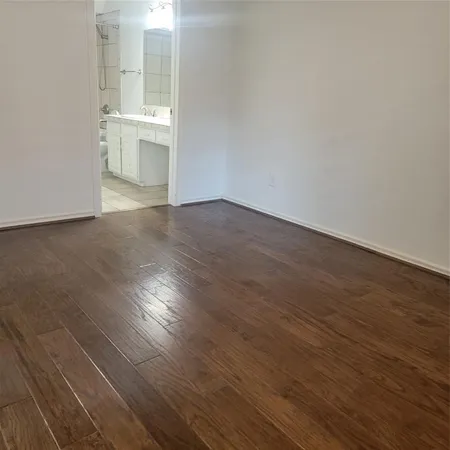 a view of a room with wooden floor and a sink