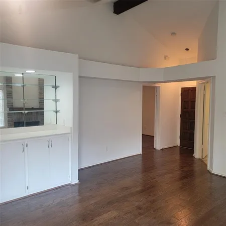 a view of a kitchen with wooden floor and a sink
