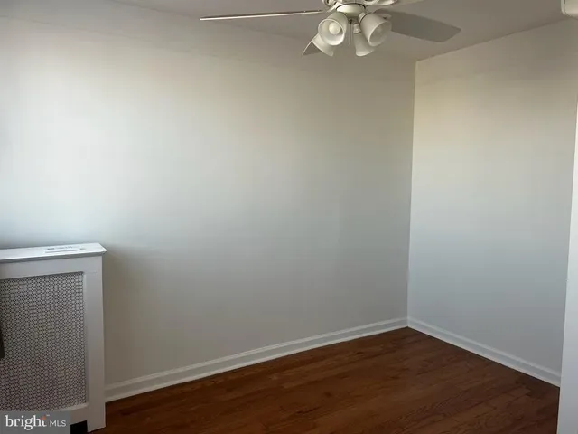 a view of a small space with wooden floor and a window