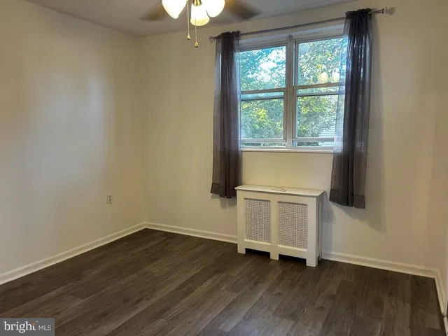 a view of a room with wooden floor and window