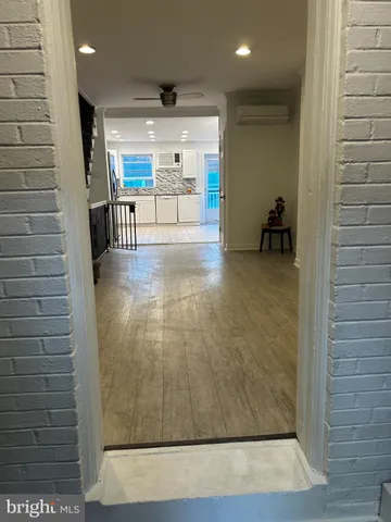 a view of a hallway with seating area