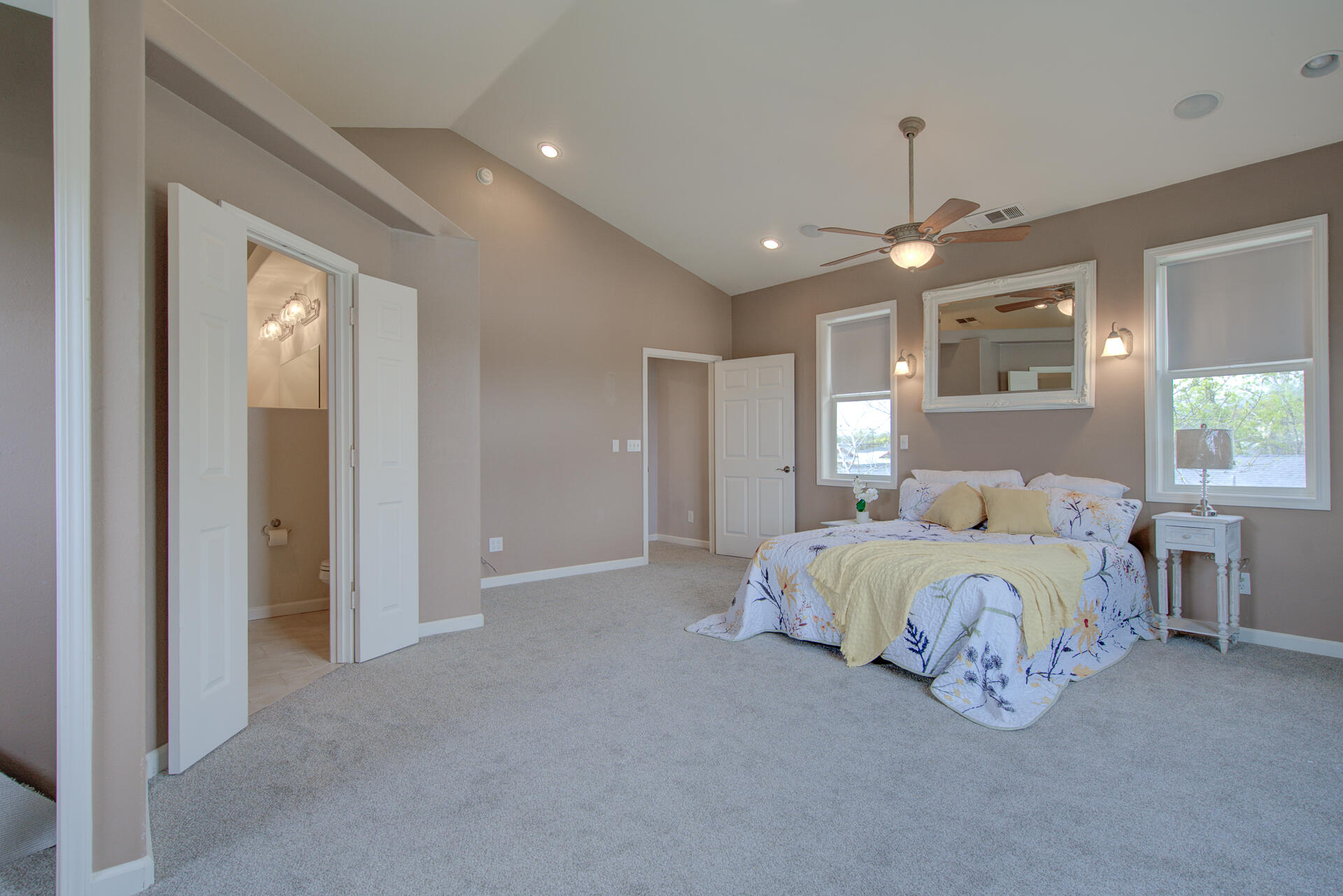 1208 Riviera Drive Redding, CA 96001 - Photo 26 of 39 a spacious bedroom with a bed and a chandelier