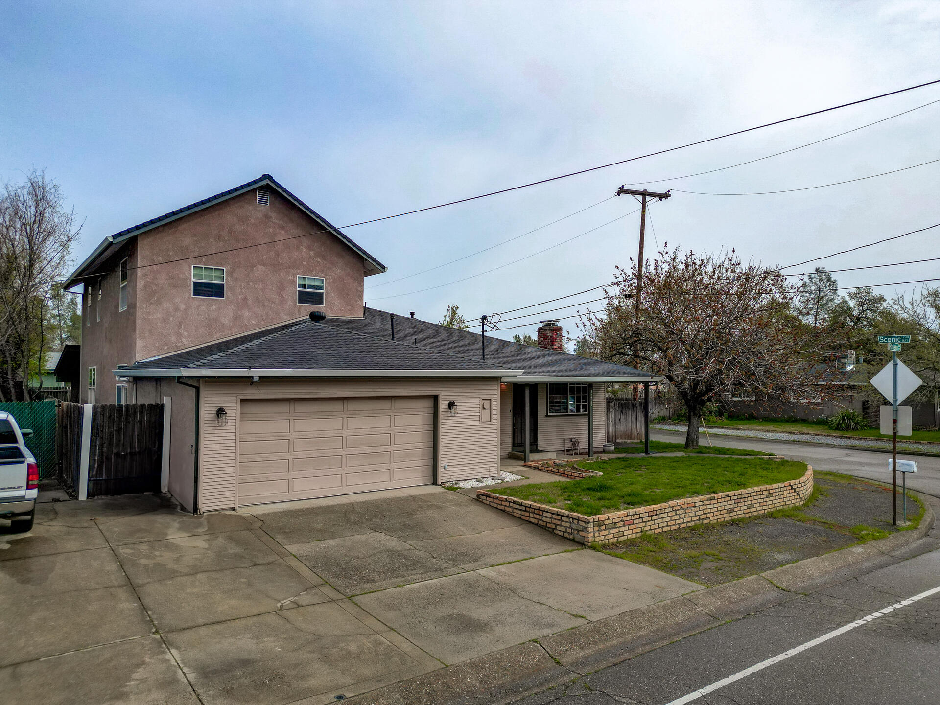 1208 Riviera Drive Redding, CA 96001 - Photo 39 of 39 a front view of a house with a yard and garage