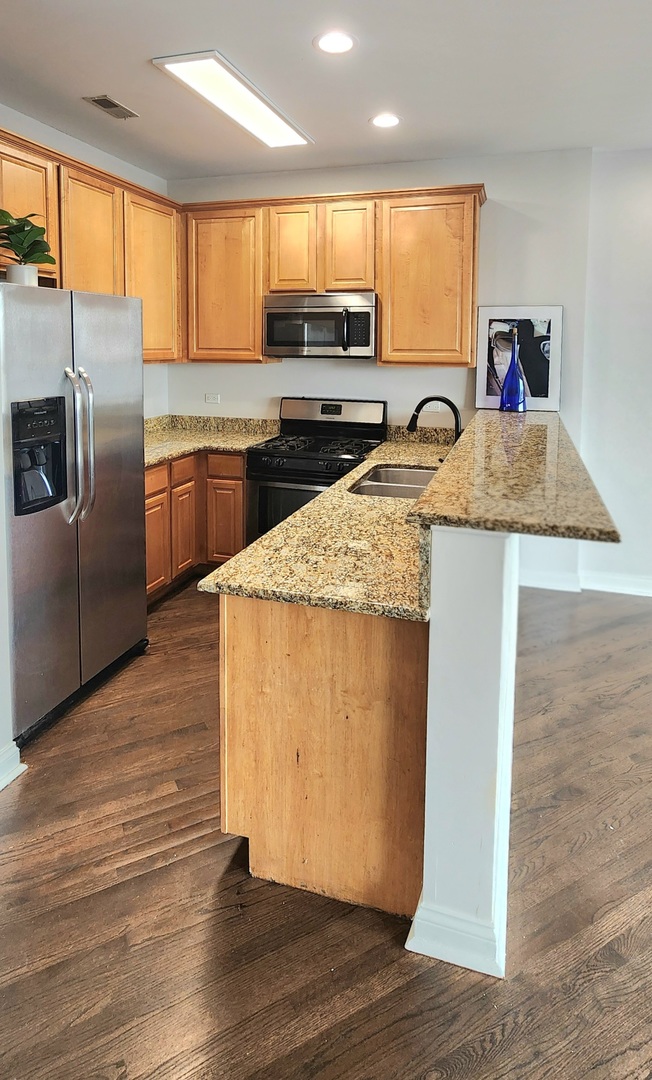 4002 South Western Avenue, Unit 4 Chicago, IL 60609 - Photo 11 of 31 a kitchen with stainless steel appliances granite countertop a sink a stove and a refrigerator