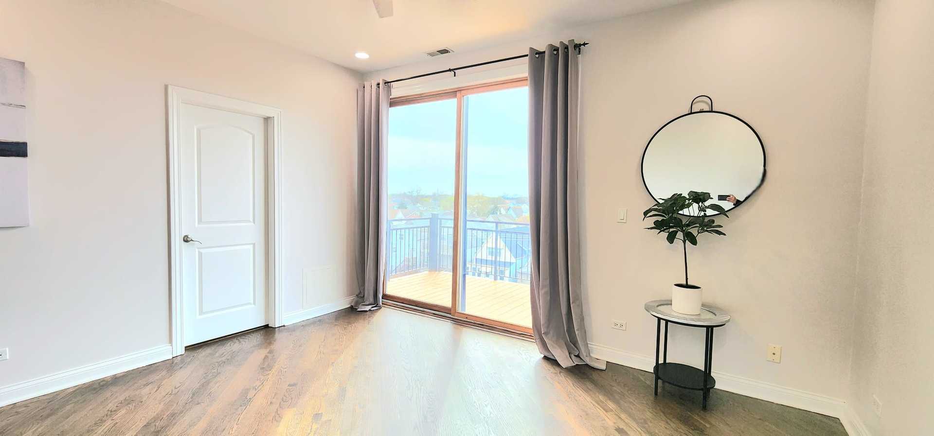 4002 South Western Avenue, Unit 4 Chicago, IL 60609 - Photo 18 of 31 a view of a room with a large windows and wooden floor