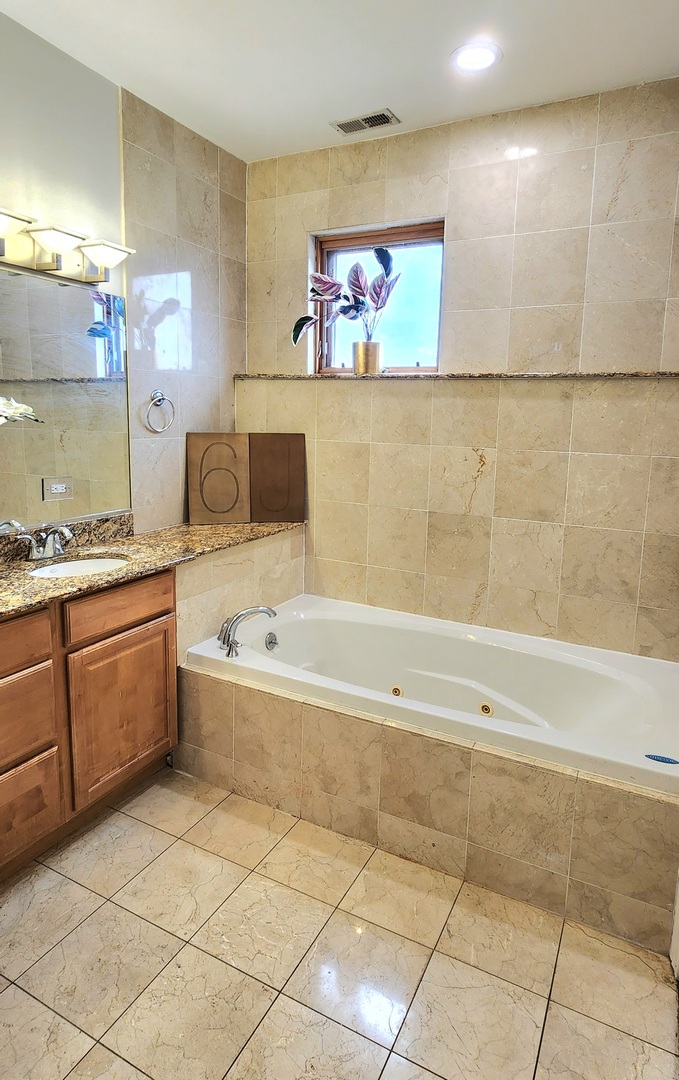 4002 South Western Avenue, Unit 4 Chicago, IL 60609 - Photo 22 of 31 a bathroom with a bathtub and a sink