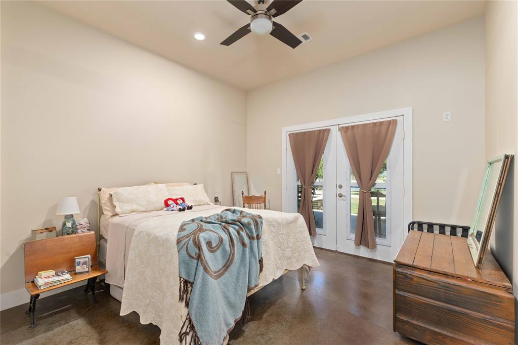 1005 Deep Water Road May, TX 76857 - Photo 23 of 40 Interior room featuring light neutral walls and dark flooring