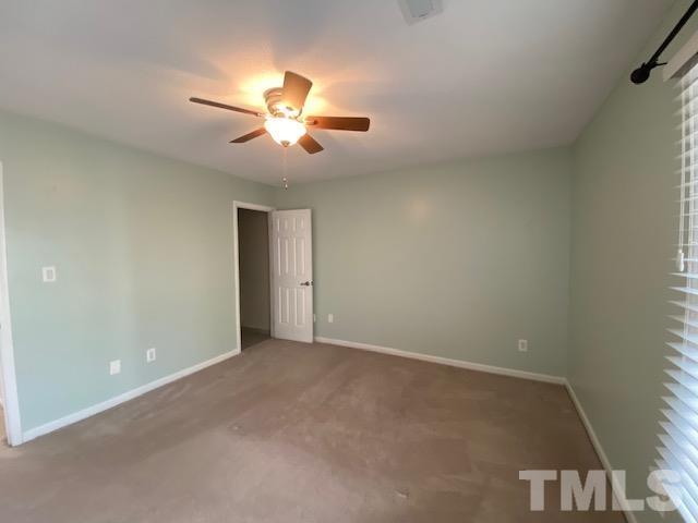 6422 Meadow View Drive Raleigh, NC 27609 - Photo 4 of 5 an empty room with a ceiling fan and a window
