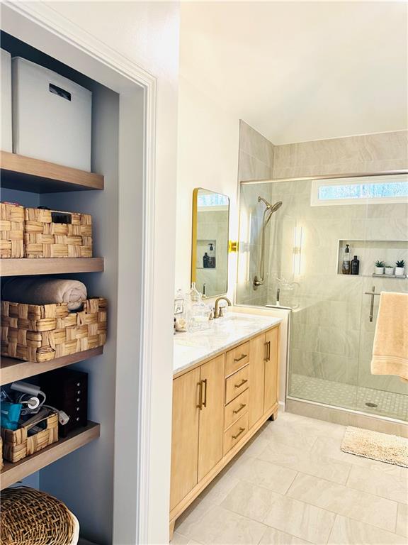 8002 Ashwell Court Woodstock, GA 30189 - Photo 12 of 14 a bathroom with a granite countertop sink a mirror and a shower