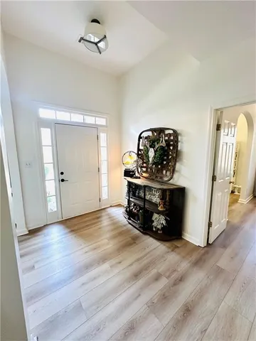 an empty room with wooden floor and ceiling fan
