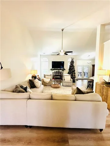 a view of living room with furniture and kitchen view