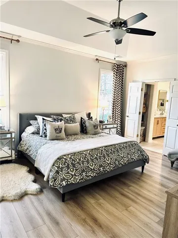 a bed sitting in a bedroom next to a window