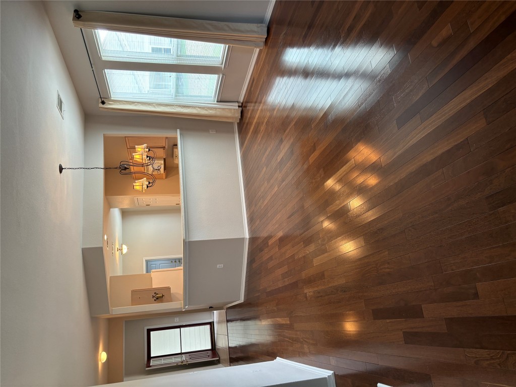 106 Bowie Circle Georgetown, TX 78633 - Photo 1 of 33 an empty room with wooden floor and kitchen view