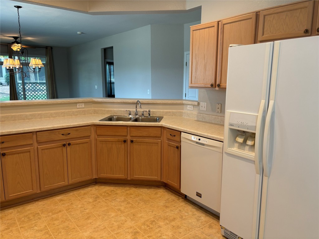 106 Bowie Circle Georgetown, TX 78633 - Photo 11 of 33 a kitchen with a sink a refrigerator and a sink