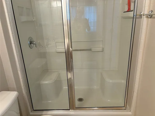 a bathroom with a glass door shower