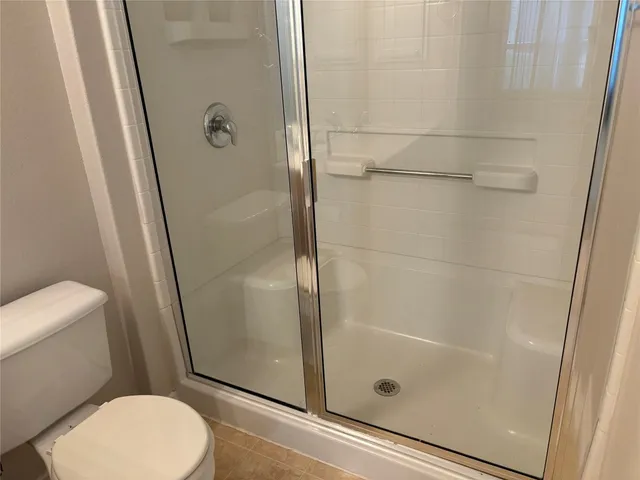 a bathroom with a shower and toilet