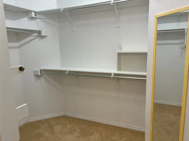 a view of a room with shelf on the wall