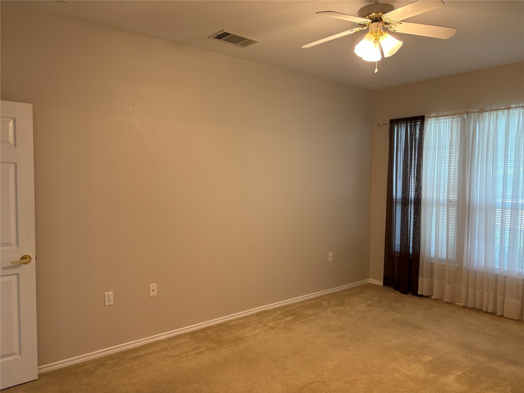 106 Bowie Circle Georgetown, TX 78633 - Photo 20 of 33 an empty room with windows and fan