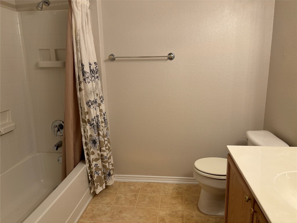 106 Bowie Circle Georgetown, TX 78633 - Photo 24 of 33 a white toilet sitting next to a bath tub