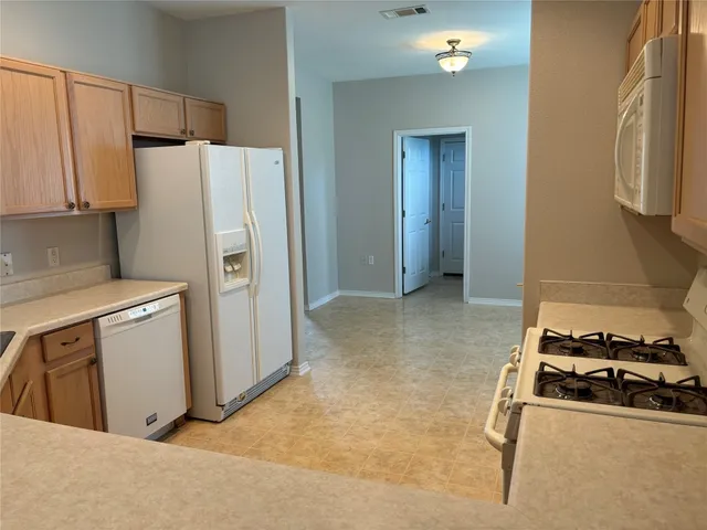 a kitchen with a refrigerator and a stove