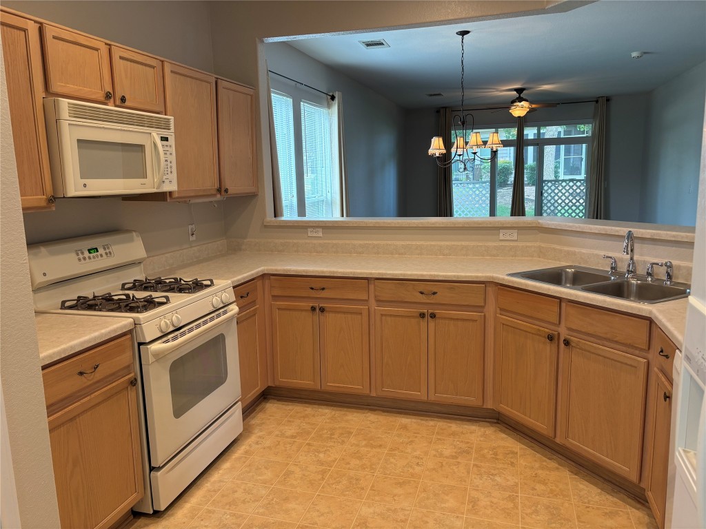 106 Bowie Circle Georgetown, TX 78633 - Photo 10 of 33 a kitchen with granite countertop a stove sink and cabinets