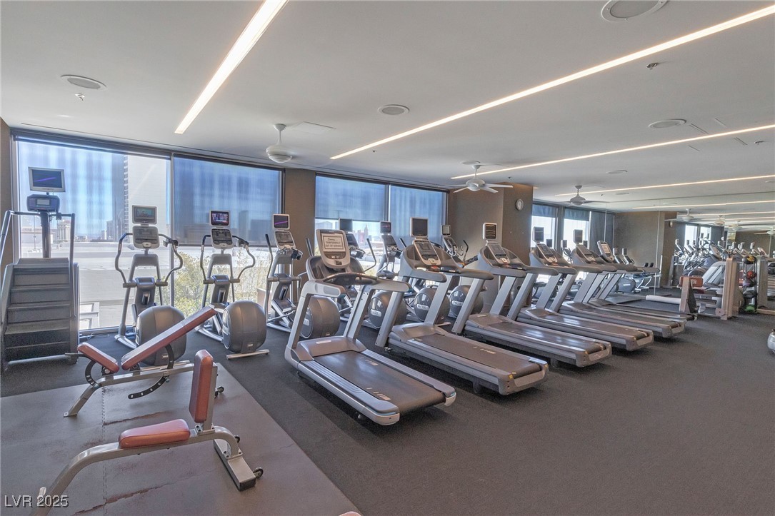 4381 West Flamingo Road, Unit 58301 Las Vegas, NV 89103 - Photo 27 of 32 Gym featuring expansive windows and ceiling fan