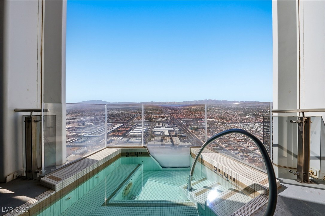 4381 West Flamingo Road, Unit 58301 Las Vegas, NV 89103 - Photo 4 of 32 View of swimming pool featuring a balcony and a mountain view