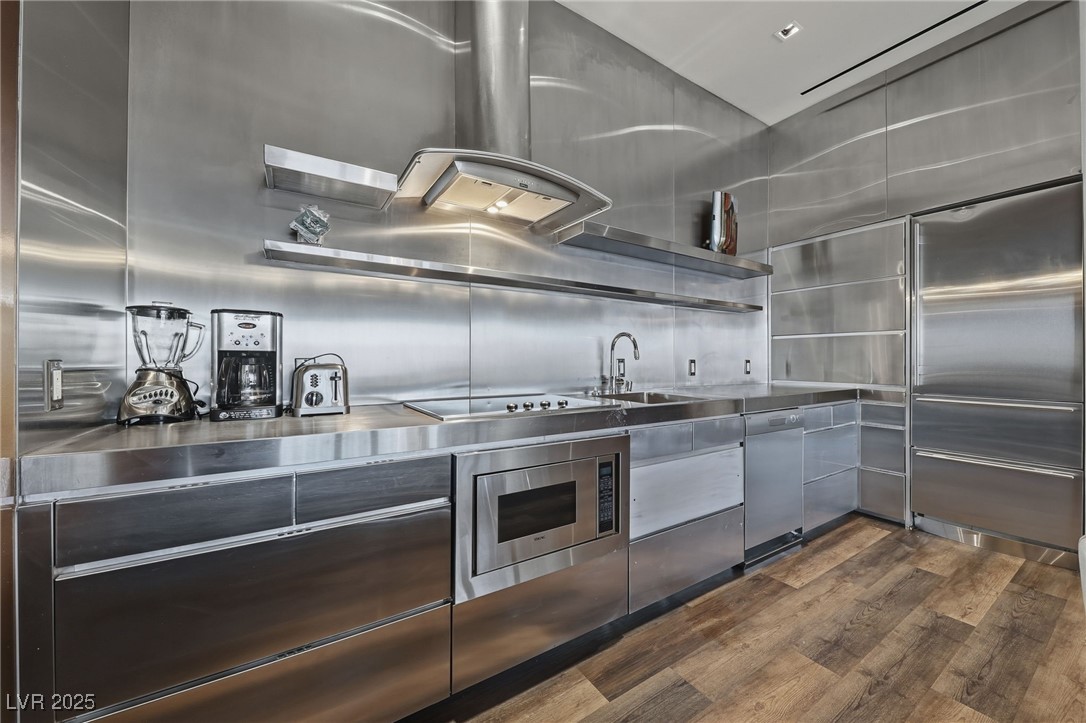 4381 West Flamingo Road, Unit 58301 Las Vegas, NV 89103 - Photo 8 of 32 Kitchen featuring stainless steel countertops, stainless steel appliances, extractor fan, and open shelves