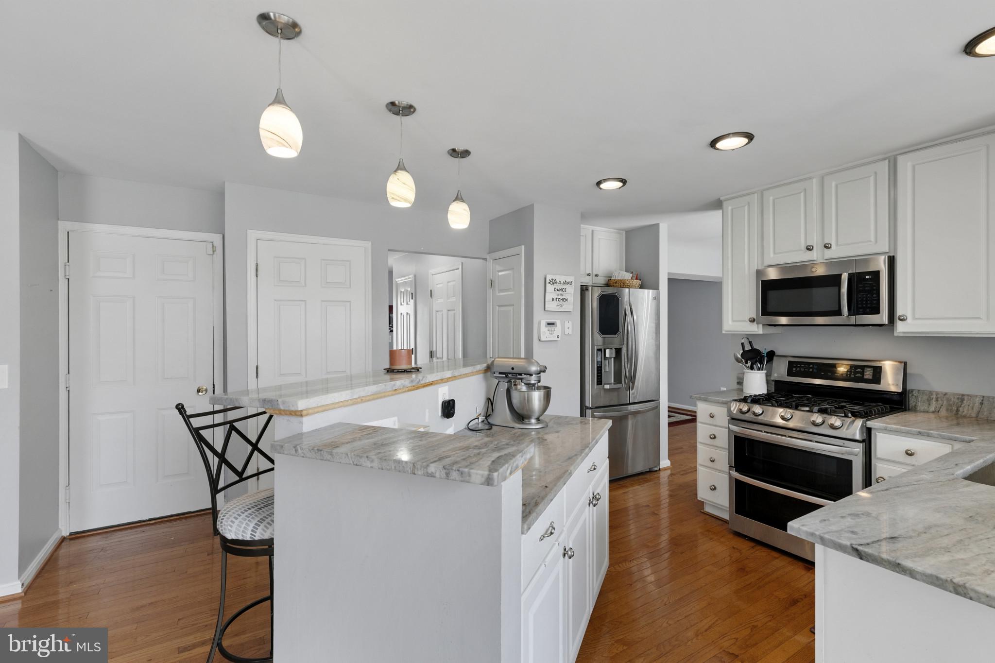 1353 Ridge Commons Boulevard Hanover, MD 21076 - Photo 8 of 39 a kitchen with stainless steel appliances granite countertop a stove refrigerator sink and microwave