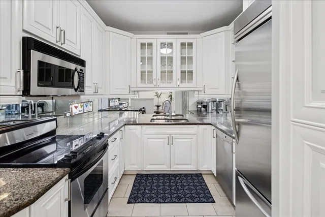 a kitchen with a sink stove and microwave