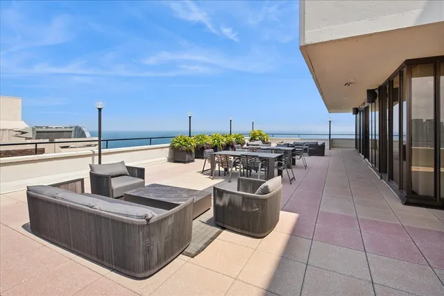 a dining hall with couches and potted plants
