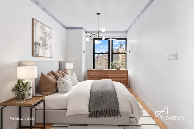 a bedroom with a large bed and a window