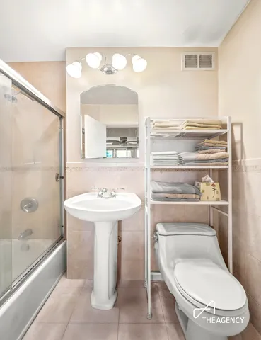 a bathroom with a sink a toilet and bathtub