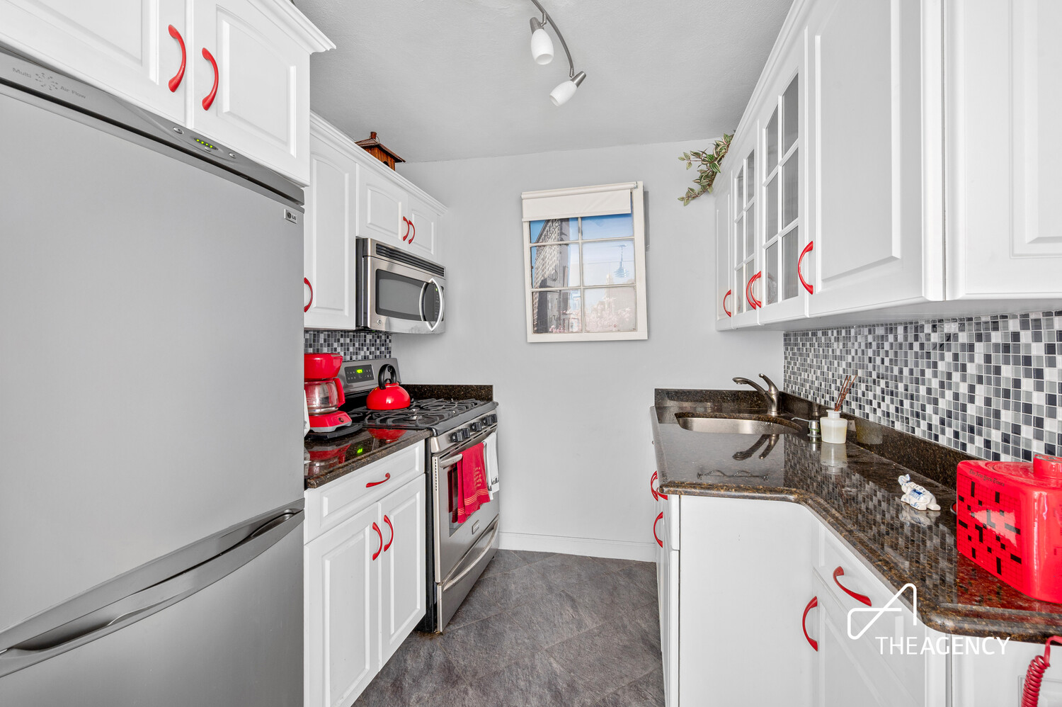 201 East 21st Street, Unit 10H Manhattan, NY 10010 - Photo 5 of 6 a kitchen with a refrigerator and a sink