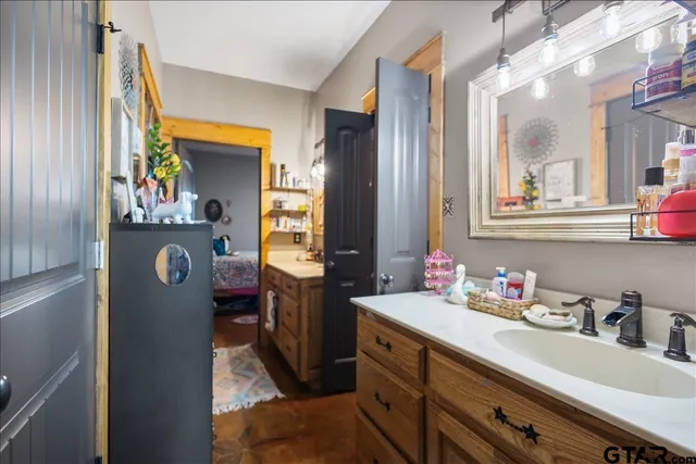 a bathroom with a sink vanity and mirror