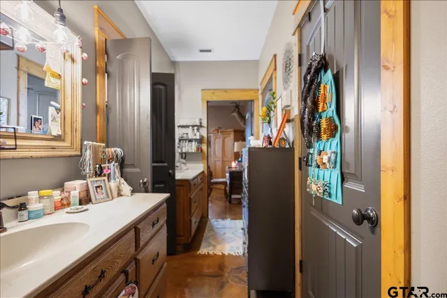 a view of walk in closet and bathroom