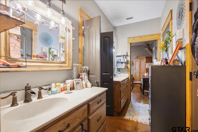 a bathroom with a sink double vanity and a mirror